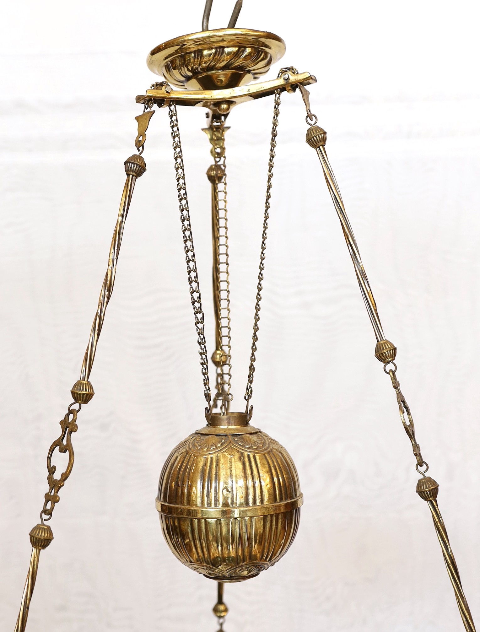 A 19th century French embossed brass counterbalanced hanging oil lamp with opaque glass shade, height 110cm. width 50cm
